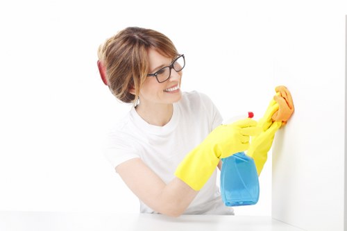 Staff using protective equipment while handling cleaning products safely